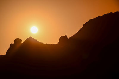 Scenic view of silhouette mountains against sky during sunset
