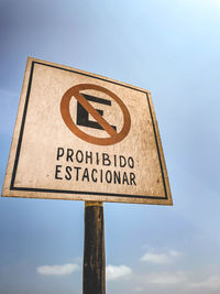 Low angle view of road sign against sky