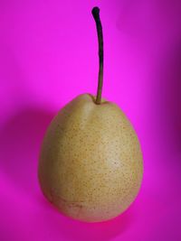 Close-up of apple against pink background