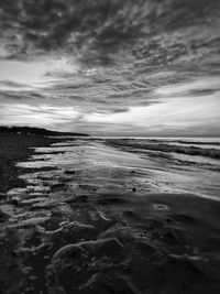 Surface level of beach against sky