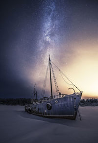 Ship in sea against sky at night