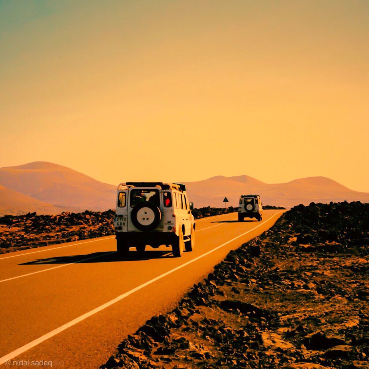 clear sky, mountain, copy space, mountain range, landscape, sunset, tranquil scene, scenics, transportation, tranquility, sand, beauty in nature, nature, desert, non-urban scene, road, text, outdoors, arid climate, hill