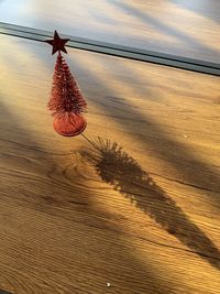 Heart shape on sand at beach against sky