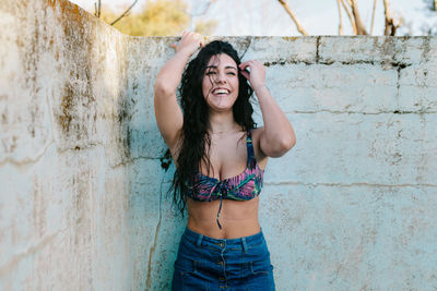 Smiling woman standing at abandoned swimming pool