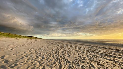 Scenic view of beach against sky during sunset