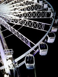 Low angle view of ferris wheel against sky