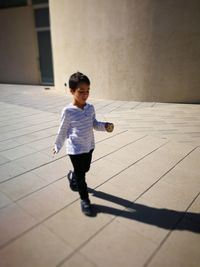 Boy playing on tiled floor