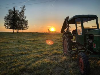 Scenic view of agricultural field against sky during sunset