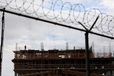 Low angle view of chainlink fence against sky