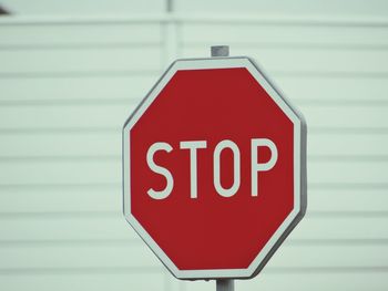 Close-up of stop sign on wall