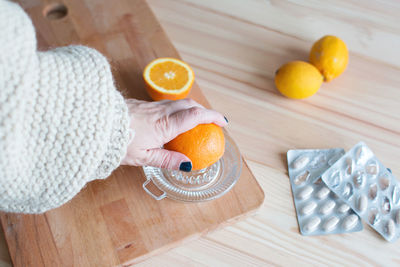 High angle view of hand holding bread on cutting board