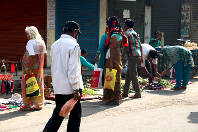People standing on street market in city