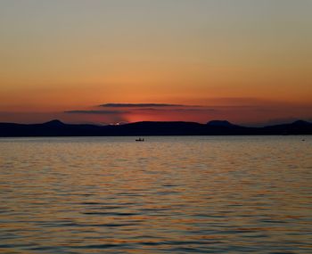 Scenic view of sea against romantic sky at sunset