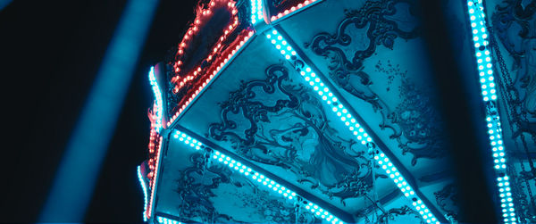 Low angle view of illuminated ceiling of carousel 