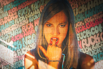 Portrait of woman with graffiti on wall
