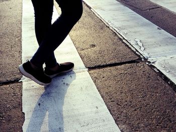 Low section of woman standing on tiled floor