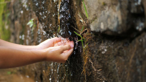 Close-up, children's hands. a child washes his hands in the clear