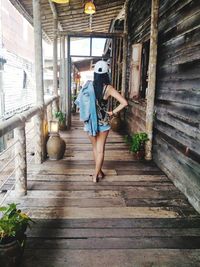 Rear view of woman walking in balcony