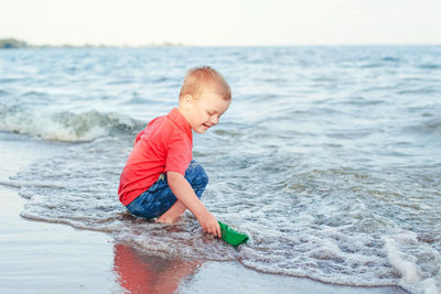 Rear view of boy on beach