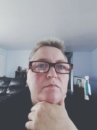 Portrait of young man wearing eyeglasses at home