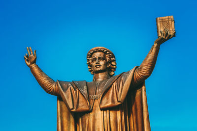 Low angle view of statue against clear blue sky