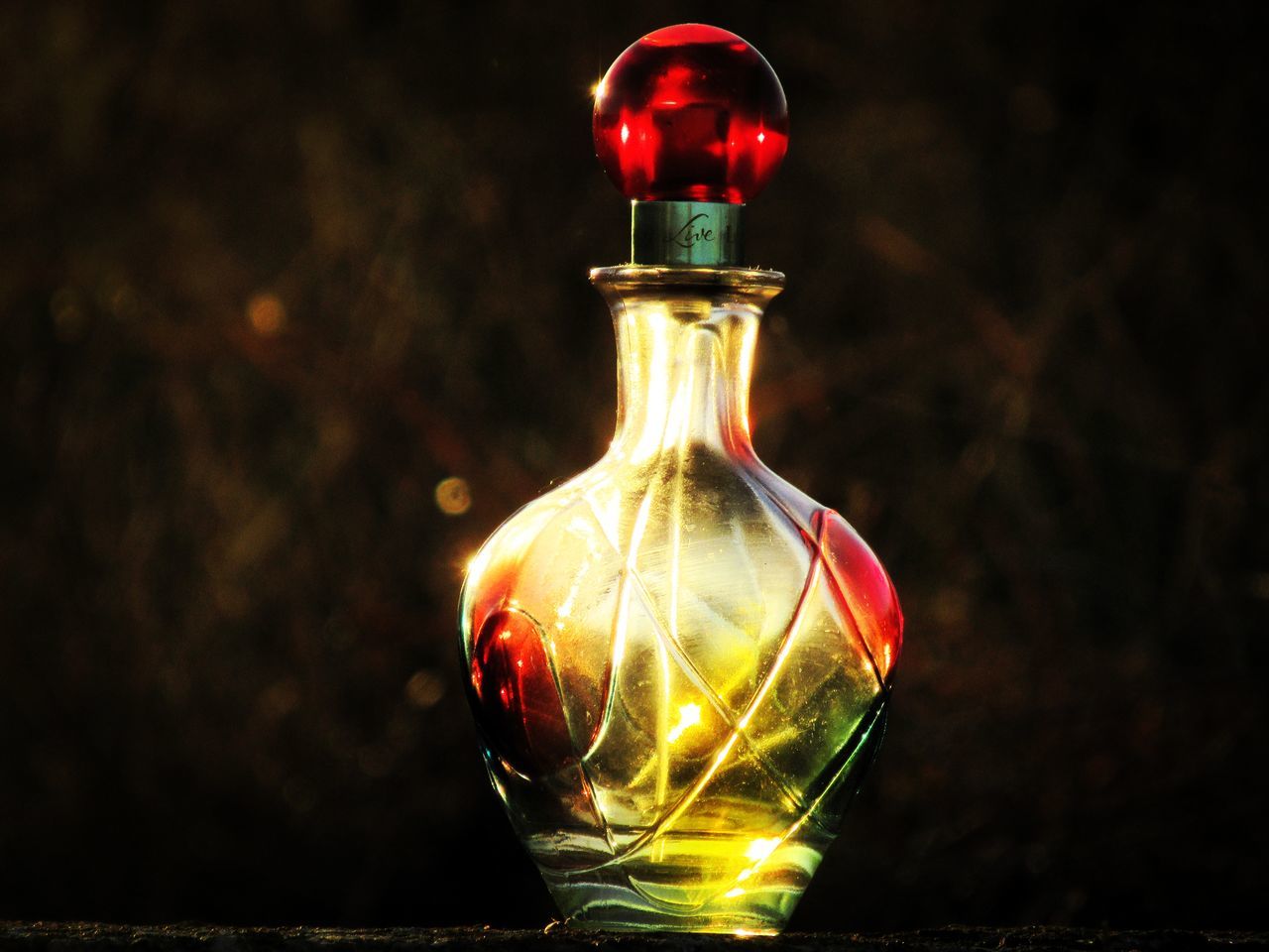 yellow, glass, red, darkness, light, night, distilled beverage, no people, illuminated, lighting equipment, indoors, lighting, single object, perfume, incandescent light bulb, container, macro photography, close-up, glowing, bottle, light bulb, focus on foreground, still life, black background