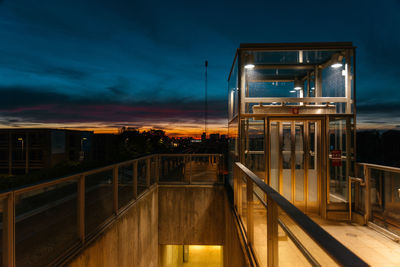 Illuminated building against sky at dusk