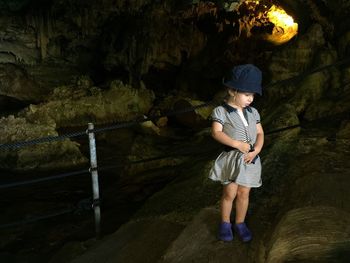 Cute girl standing on steps at green grotto caves