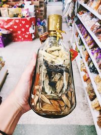 Close-up of hand holding glass jar