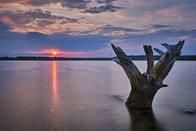 Scenic view of lake against sky during sunset