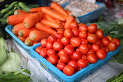 High angle view of tomatoes in basket for sale at market stall