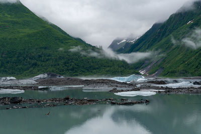 Scenic view of lake and mountains against sky