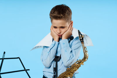 Portrait of boy against blue sky