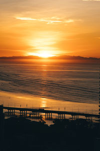 Scenic view of sea against orange sky