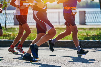 Running men. sportsmen jogging in sportswear on city road. healthy lifestyle, fitness, marathon