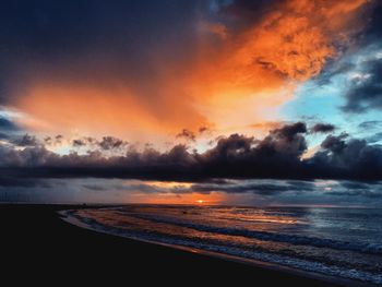 Scenic view of dramatic sky over sea during sunset