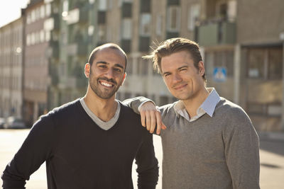 Portrait of mid adult male friends enjoying together outdoors