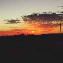 Silhouette landscape against sky during sunset