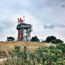 Traditional windmill on field against sky