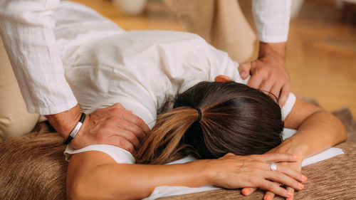 Shiatsu arms and shoulder massage. therapist massaging the small and large intestine meridians.