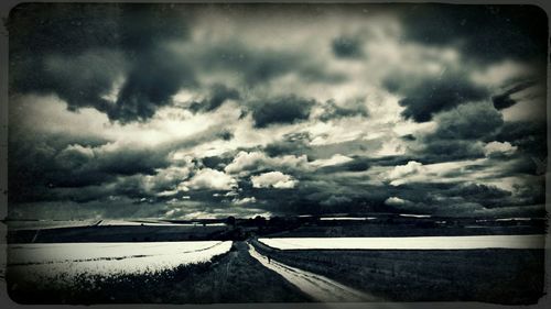 Scenic view of sea against cloudy sky