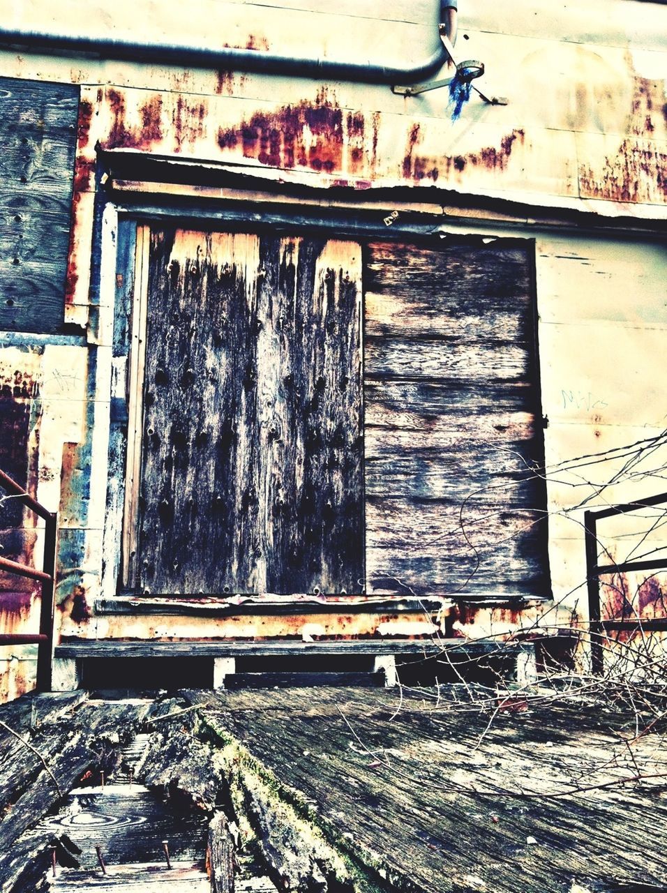 abandoned, built structure, obsolete, architecture, damaged, run-down, building exterior, house, deterioration, old, wall - building feature, bad condition, garbage, weathered, messy, graffiti, day, window, wood - material, no people