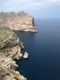 Rock formation in sea against sky