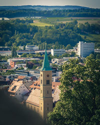 High angle view of townscape by trees in city