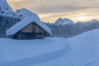 Snow covered landscape against sky