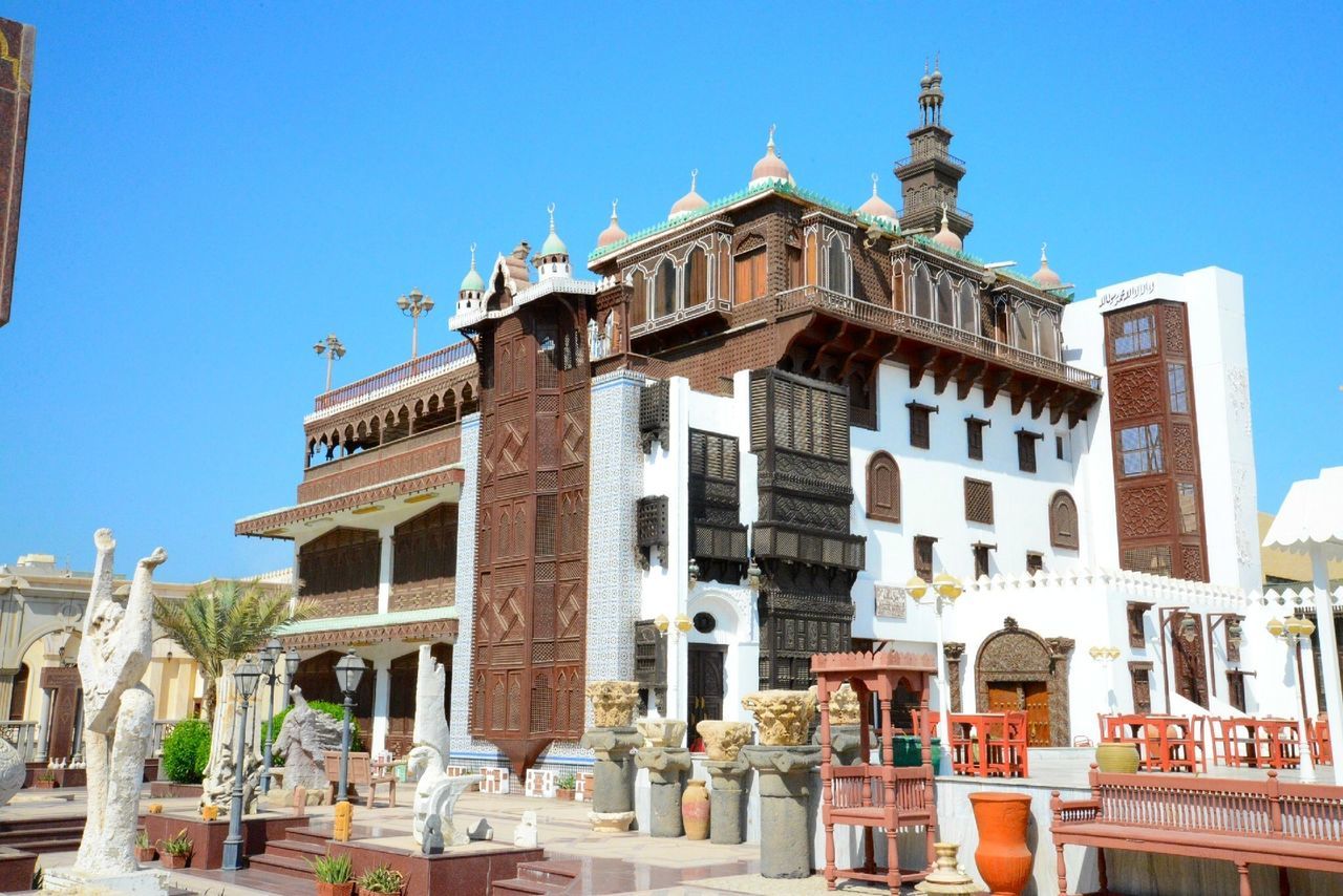 architecture, building exterior, built structure, clear sky, blue, place of worship, religion, low angle view, spirituality, famous place, sunlight, travel destinations, church, history, dome, facade, copy space, tourism, statue