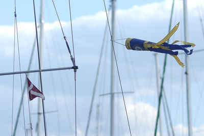 Low angle view of flags hanging against sky