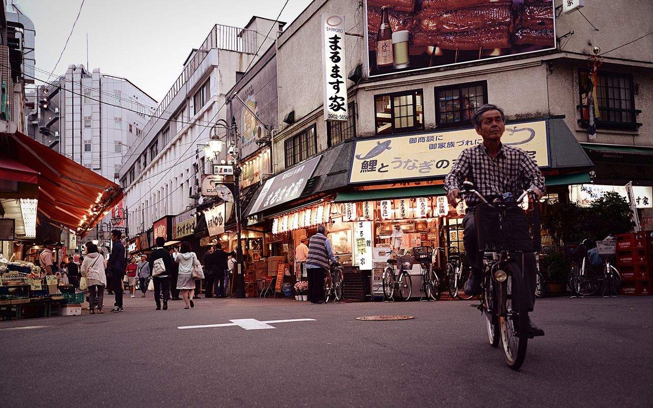 building exterior, architecture, street, built structure, city, lifestyles, city life, men, walking, leisure activity, person, full length, city street, road, incidental people, outdoors, casual clothing, sidewalk