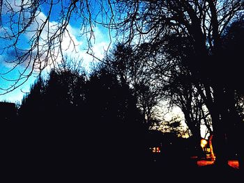 Low angle view of silhouette trees against sky at sunset