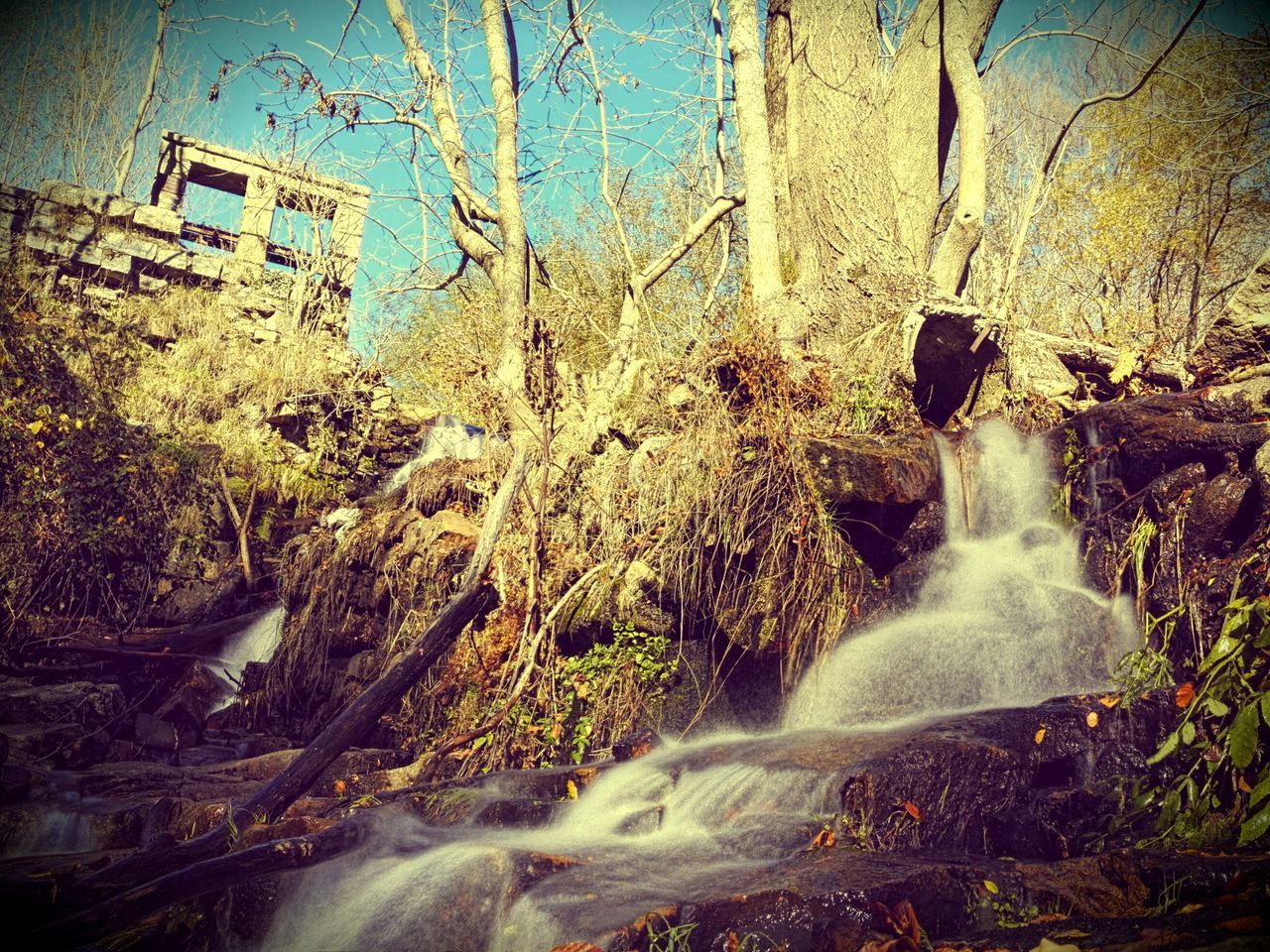 WATER FLOWING OVER ROCKS